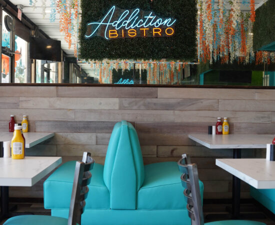 Restaurant view indoors with Addiction Bistro neon sign