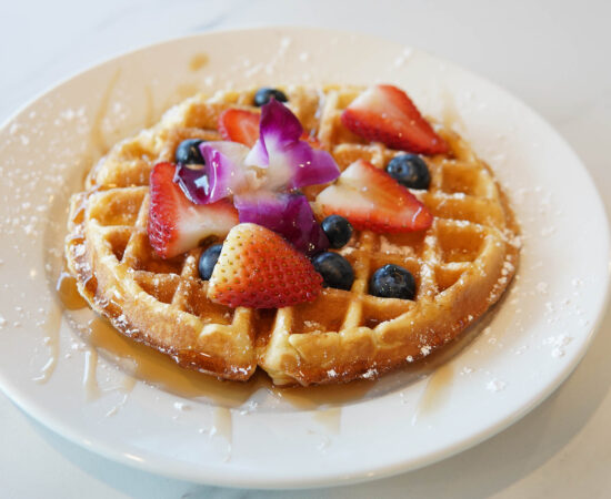 Waffle with fresh berries and powdered sugar